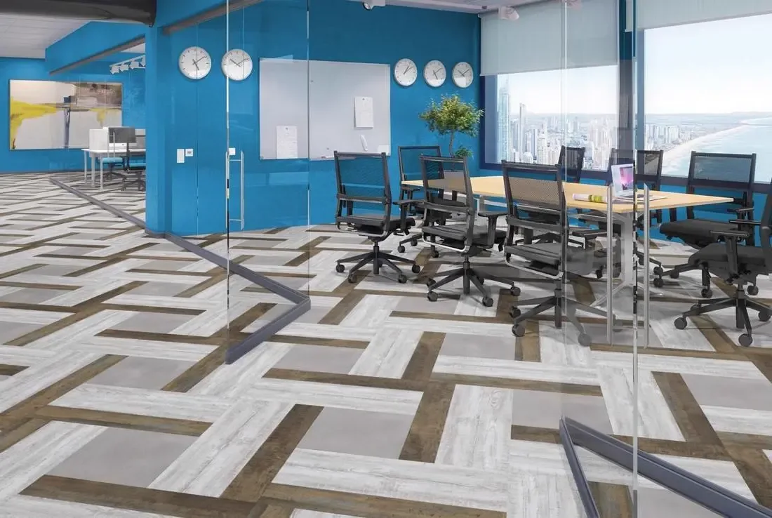 Office meeting room with patterned grey and brown plank flooring and glass walls