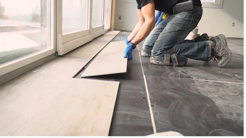 Installers setting large-format porcelain tiles on a floor