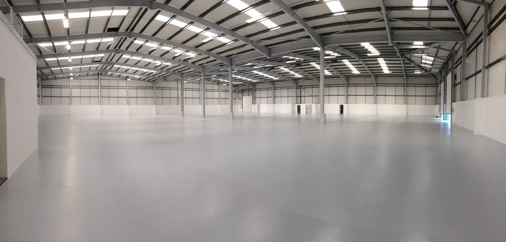 Large warehouse with a smooth grey coated concrete floor