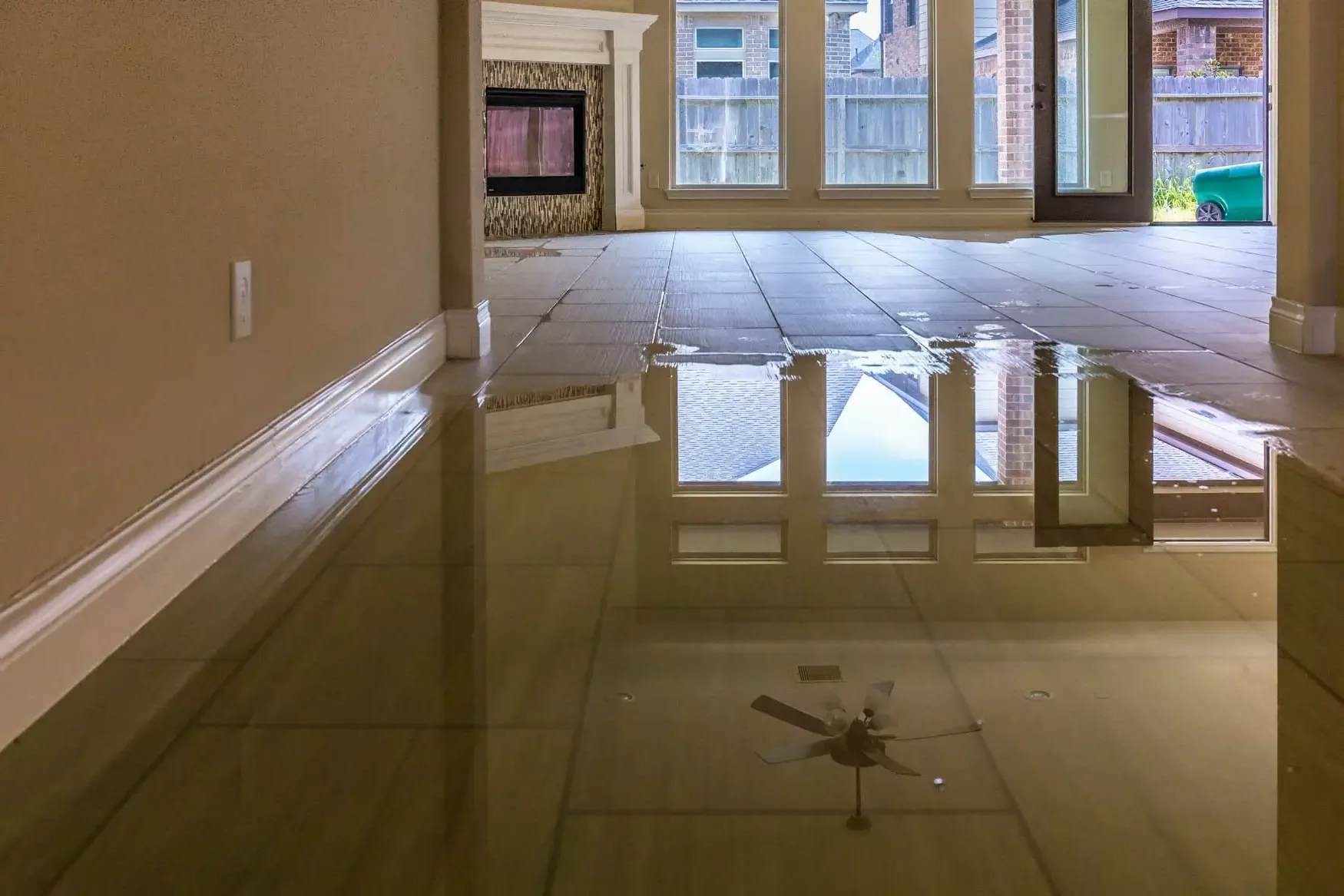 Standing water flooding a tiled living room floor