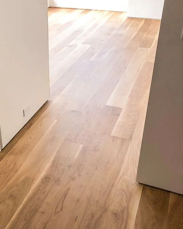 Long runs of light oak plank flooring through an open main floor